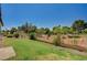 Fenced backyard showcasing the well-manicured lawn and vibrant landscaping at 5401 Broadwater Ln, Las Vegas, NV 89130