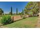 Backyard featuring mature trees and landscaping with access to the golf course at 5401 Broadwater Ln, Las Vegas, NV 89130