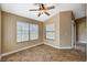 Bedroom with ceiling fan, windows, and tile floors at 5401 Broadwater Ln, Las Vegas, NV 89130