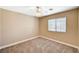 This neutral bedroom has a ceiling fan, a double-hung window, and plush carpeting at 5401 Broadwater Ln, Las Vegas, NV 89130