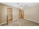 Carpeted bedroom offers a ceiling fan, closet, and an attached bathroom at 5401 Broadwater Ln, Las Vegas, NV 89130