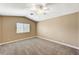 Large neutral bedroom features a ceiling fan, a double-hung window, and vaulted ceilings at 5401 Broadwater Ln, Las Vegas, NV 89130