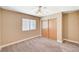Neutral bedroom features a ceiling fan, double-hung window, and a double door closet at 5401 Broadwater Ln, Las Vegas, NV 89130