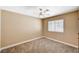 This neutral bedroom offers a ceiling fan, a double-hung window, and plush carpeting at 5401 Broadwater Ln, Las Vegas, NV 89130