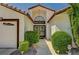 Welcoming entrance with double doors, a modern light fixture, and manicured landscaping at 5401 Broadwater Ln, Las Vegas, NV 89130