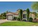 Charming single-story home with well-manicured lawn, mature trees, and a two-car garage at 5401 Broadwater Ln, Las Vegas, NV 89130