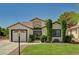 Charming single-story home with well-manicured lawn, mature trees, and a two-car garage at 5401 Broadwater Ln, Las Vegas, NV 89130