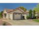 Charming single-story home with well-manicured lawn, mature trees, and a two-car garage at 5401 Broadwater Ln, Las Vegas, NV 89130