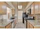 Well-equipped kitchen features granite counters and modern appliances at 5401 Broadwater Ln, Las Vegas, NV 89130