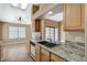 Kitchen featuring granite counters, tile backsplash, and modern appliances at 5401 Broadwater Ln, Las Vegas, NV 89130