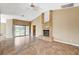 Spacious living room features tile floors, a fireplace, and a sliding door to the backyard at 5401 Broadwater Ln, Las Vegas, NV 89130