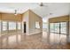 Open living room with neutral walls, tile flooring, and large windows at 5401 Broadwater Ln, Las Vegas, NV 89130