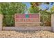 Castle Bay Shores community sign with stone base and decorative flowers at 5401 Broadwater Ln, Las Vegas, NV 89130