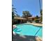 Resort-style swimming pool with inviting lounge area, shaded seating, and lush landscaping for relaxation and leisure at 5576 W Rochelle Ave # 27A, Las Vegas, NV 89103
