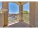 Comfortable covered balcony offering textured columns with railings and a neighborhood view at 5855 Valley Dr # 2106, North Las Vegas, NV 89031
