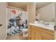 Bright bathroom featuring a single sink vanity and a unique dinosaur-themed shower curtain at 5855 Valley Dr # 2106, North Las Vegas, NV 89031