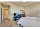 Relaxing bedroom area with wood-look floors, neutral paint, and a comfortable workspace at 5855 Valley Dr # 2106, North Las Vegas, NV 89031