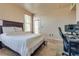 Bedroom with wood-look floors, a ceiling fan, and a desk area with computer setup at 5855 Valley Dr # 2106, North Las Vegas, NV 89031