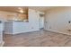 Spacious living room with hardwood floors, neutral paint, and an open layout to the kitchen at 5855 Valley Dr # 2106, North Las Vegas, NV 89031