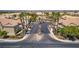 A street view of a community with well maintained homes, palm trees, and lush landscaping at 5855 Valley Dr # 2106, North Las Vegas, NV 89031