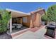Backyard featuring covered patio, grill and landscaping at 5933 Perfect View St, Las Vegas, NV 89130