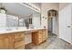 Bathroom showcasing a double vanity, tile flooring, and arched doorway at 5933 Perfect View St, Las Vegas, NV 89130