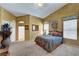 Spacious bedroom featuring warm tones, natural light, and an en-suite bathroom at 5933 Perfect View St, Las Vegas, NV 89130