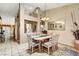 View of the dining room with tile floors, a decorative mirror, and a six-chair dining table at 5933 Perfect View St, Las Vegas, NV 89130