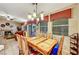 Bright dining area with large windows, a wooden table and chairs set, and views of the backyard at 5933 Perfect View St, Las Vegas, NV 89130