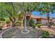 Landscaped front yard featuring mature trees and a well-maintained lawn at 5933 Perfect View St, Las Vegas, NV 89130