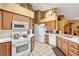 Well-lit kitchen featuring white appliances, countertops, and light brown cabinetry at 5933 Perfect View St, Las Vegas, NV 89130