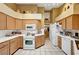 Bright kitchen with light brown cabinetry, white countertops and view to next room at 5933 Perfect View St, Las Vegas, NV 89130