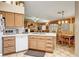 Open kitchen view with dining area, a white countertop and light brown cabinetry at 5933 Perfect View St, Las Vegas, NV 89130