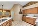 Spacious kitchen featuring tiled countertops, light brown cabinets, and view of dining area at 5933 Perfect View St, Las Vegas, NV 89130
