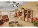Open concept living area with tile floors, custom built-ins, and a ceiling fan at 5933 Perfect View St, Las Vegas, NV 89130
