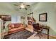 Office with a brown leather couch and guitars on the wall at 5933 Perfect View St, Las Vegas, NV 89130