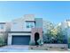 Contemporary two-story home featuring a two-car garage, desert landscaping, and a private front entrance at 6230 Bravestar Ct, Las Vegas, NV 89141