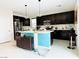 Spacious kitchen boasts a large center island, dark cabinetry, modern appliances, and ample counter space at 6230 Bravestar Ct, Las Vegas, NV 89141