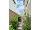 Side yard with block wall and green bushes at 6230 Bravestar Ct, Las Vegas, NV 89141