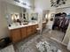 Primary bathroom featuring dual sinks, vanity, and a walk-in closet at 6329 Kitamaya St, North Las Vegas, NV 89031