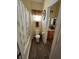 Cozy bathroom with wood-look flooring, framed mirror, and tub with patterned shower curtain at 6329 Kitamaya St, North Las Vegas, NV 89031