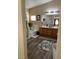 Bright bathroom featuring a large soaking tub, dual vanities, and dark wood-style floors at 6329 Kitamaya St, North Las Vegas, NV 89031