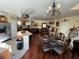 Open dining and living area showcasing elegant decor, chandelier, and stainless steel appliances at 6329 Kitamaya St, North Las Vegas, NV 89031