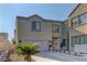 Inviting two-story home featuring a two-car garage, tidy landscaping, and charming front entrance at 6329 Kitamaya St, North Las Vegas, NV 89031