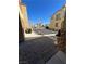 View looking out to the community street, manicured plants, and stylish stone accents enhance curb appeal at 6329 Kitamaya St, North Las Vegas, NV 89031