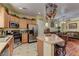 Modern kitchen with stainless steel appliances, island with seating, and open layout into living area at 6329 Kitamaya St, North Las Vegas, NV 89031