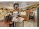 Traditional kitchen with hardwood floors, a center island, stainless steel appliances and adjacent dining area at 6329 Kitamaya St, North Las Vegas, NV 89031