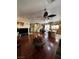 Spacious living room with hardwood floors, ceiling fan, open floorplan, and natural light at 6329 Kitamaya St, North Las Vegas, NV 89031