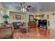 Cozy living room featuring hardwood floors and a decorative ceiling fan at 6329 Kitamaya St, North Las Vegas, NV 89031