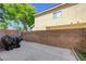 Enclosed backyard with a concrete patio and a brick wall, perfect for outdoor living and entertaining at 6533 Sundown Heights Ave, Las Vegas, NV 89130
